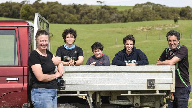 Sophie Bowker, left, and husband Matt, right, with sons Chris, 16, Charlie, 12, and Lachy, 18, at their Kangaroobie property at Princetown on the Great Ocean Road, where they run a school camp and beef cattle business. Picture: Dannika Bonser