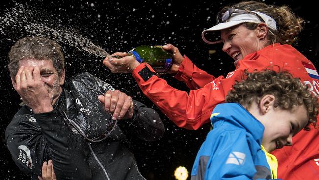 Dutch trimmer Carolijn Brouwer sprays champagne on French skipper Charles Caudrelier following victory in an epic leg of the Volvo Ocean Race.