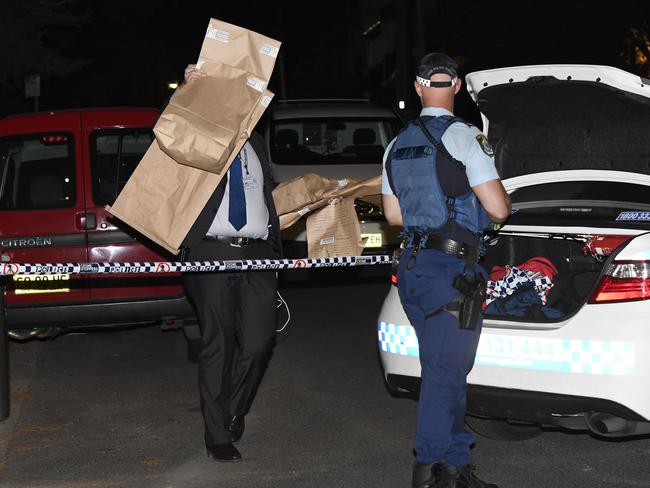 Police remove evidence bags from the scene. Picture: Gordon McComiskie