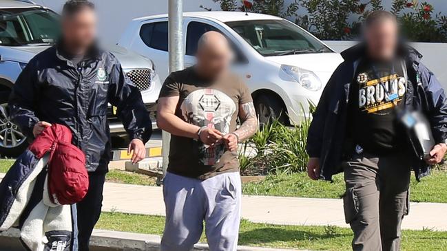 Police arrest a man after raids on 22 homes across western Sydney at 6am today. Picture: NSW Police