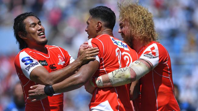 Timothy Lafaele of the Sunwolves celebrates scoring a try with his teammates.