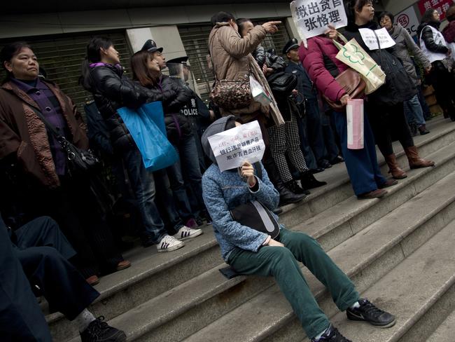 The sign at lower centre reads, "ICBC and Bank of China are cheater banks. They sell fraudulent products that take ordinary people's hard-earned money.” Another calls for the removal of an official.