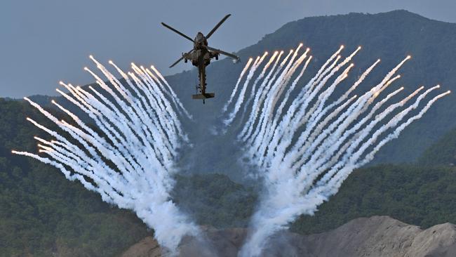 An Apache AH-64 helicopter fires flares during a South Korea-US joint military drill in South Korea. The Australian Defence Force’s Army Aviation is expected to base 29 of the attack helicopters in Townsville from 2025. Picture: Jung Yeon-Je/AFP