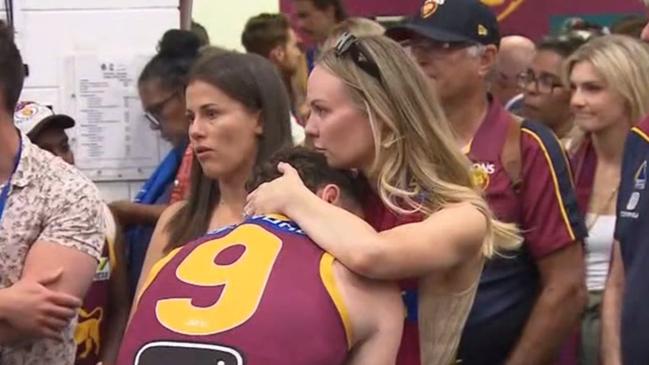 Lachie Neale consoled by his wife. Photo: Channel 7 News.