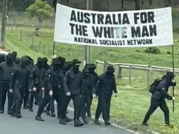 ADELAIDE, AUSTRALIA - NewsWire Photos, DECEMBER 18, 2023. Screen grabs from supplied viedo. A motel in a quiet Adelaide suburb has been targeted by neo-Nazis who staged a protest in broad daylight.  Six members of the neo-Nazi group Nationalist Socialist Network were captured on video walking down Main North Rd in the northernAdelaide suburb of Pooraka on Sunday before stopping at the Pavlos Motel. The balaclava-clad men were then seen performing Sieg Hail salutes, also known as Nazi or Hitler salutes, in the carport ofthe motel while being led through chants by a man carrying a megaphone.  Picture : NCA NewsWire