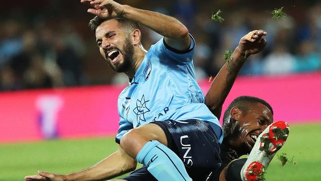 Wanderers’ Rashid Mahazi brings down Sydney’s Michael Zullo.