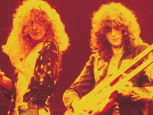 1970s pic of singer Robert Plant (l) and guitarist Jimmy Page from band "Led Zeppelin" - music groups bands performing guitar tambourine