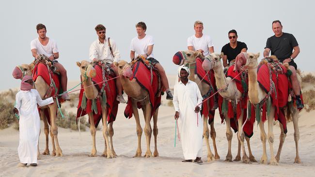 Swans players Luke Parker, Dane Rampe, Callum Mills, Isaac Heeney, Josh Kennedy and coach John Longmire on a camel ride during a safari to the desert as part of the Sydney Swans trip to Doha, Qatar. Picture: Phil Hillyard