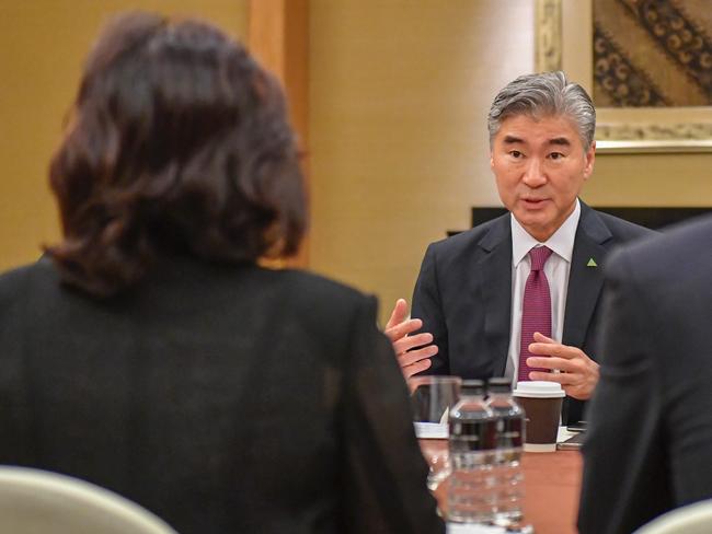 US Ambassador Sung Kim talks with members of the North Korean delegation.