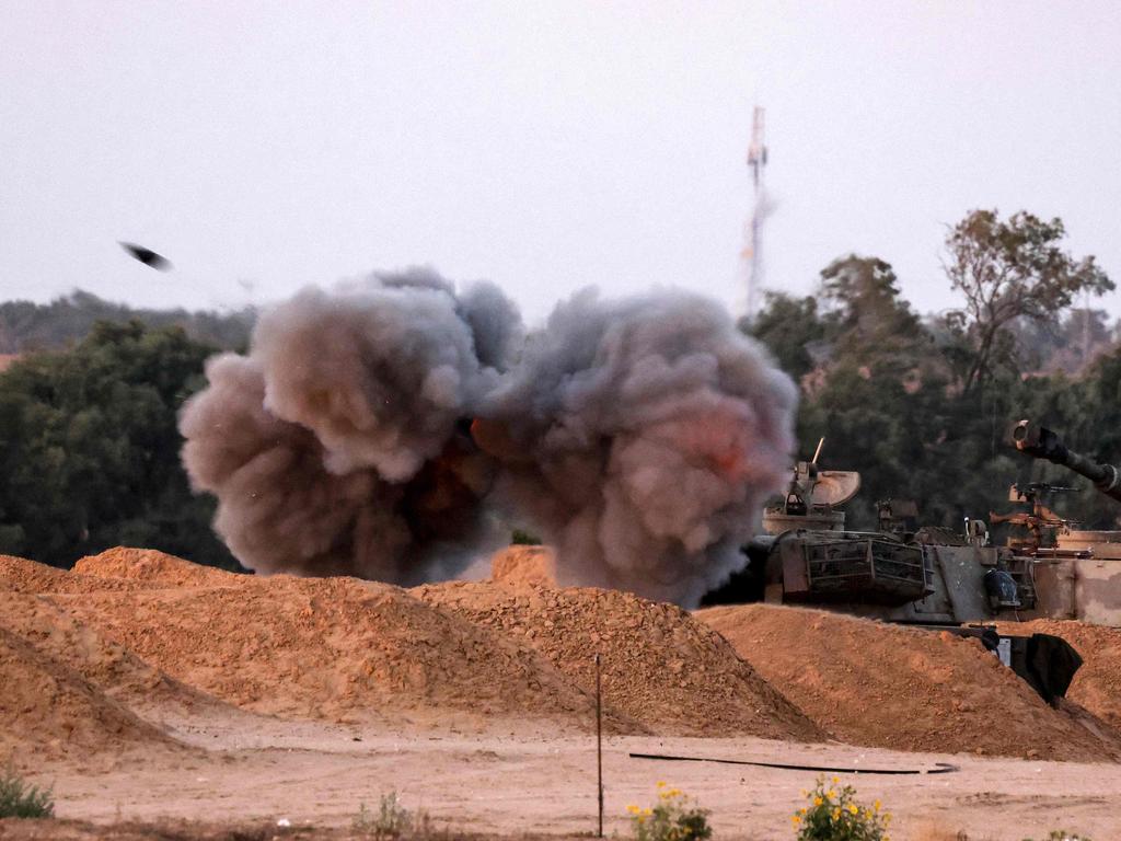 An Israeli mobile artillery unit fires a shell from a border position in southern Israel toward the Gaza Stri. Picture: AFP