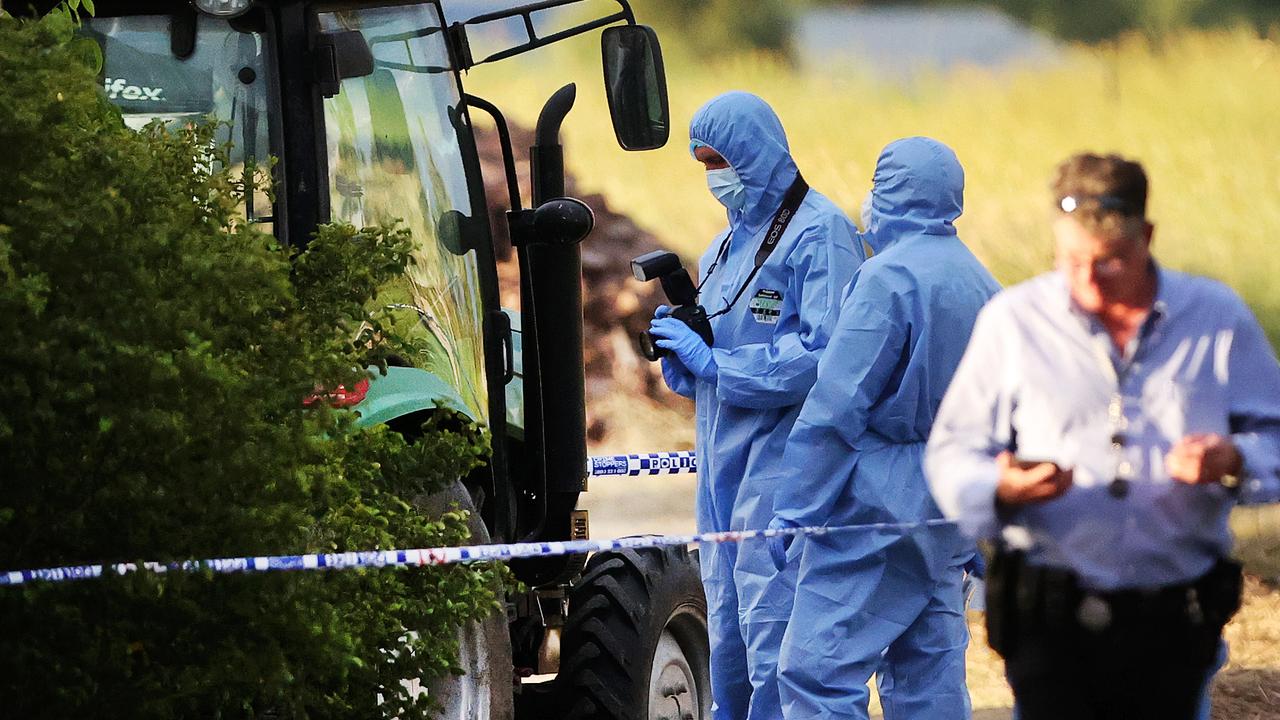 Forensice police take photos of the tractor. Picture: Nigel Hallett