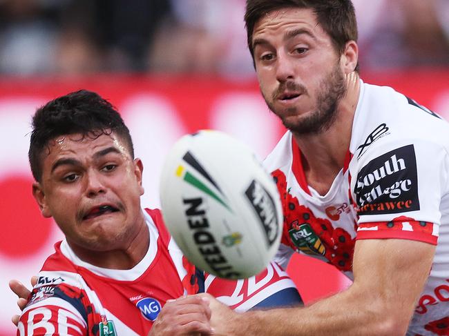 Roosters' Latrell Mitchell offloads ahead of Dragon's Ben Hunt during the ANZAC DAY match between the Sydney Roosters and St. George-Illawarra Dragons at Allianz Stadium. Picture. Phil Hillyard