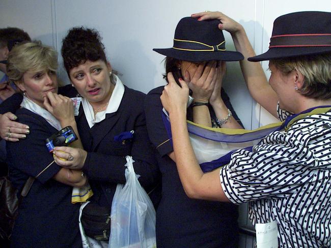 Flight attendants hug each other after the final Ansett flight into Melbourne.