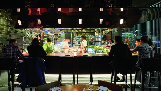 Intimate: take a high chair at the bar, face to face with the chefs. Picture: Jane Dempster