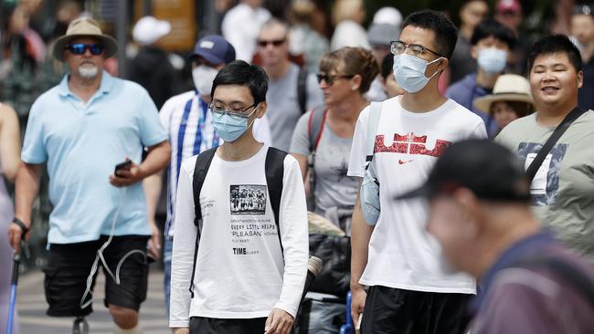 SYDNEY, AUSTRALIA - NewsWire photos NOVEMBER 21, 2022: People are seen wearing masks and choosing not to wear them at Circular Quay in Sydney. Picture: NCA NewsWire / Dylan Coker