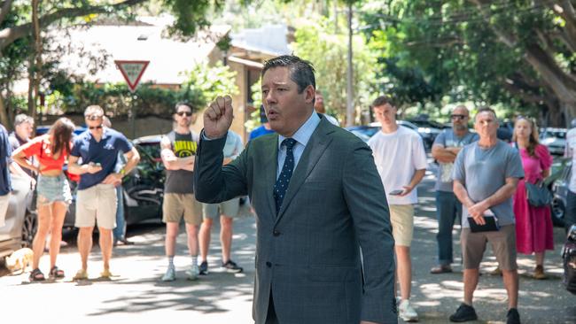 Auctioneer Scott Kennedy-Green and a crowd of bidders and curious neighbours. Picture: Thomas Lisson