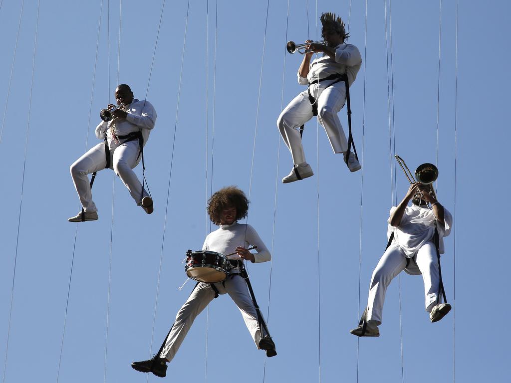 Musicians perform while hanging from cables during the Olympic torch relay in Sao Paulo, Brazil, Sunday, July 24, 2016. The three-month torch relay across Brazil will end at the opening ceremony on Aug. 5, in Rio de Janeiro’s Maracana stadium. Picture: AP Photo/Andre Penner