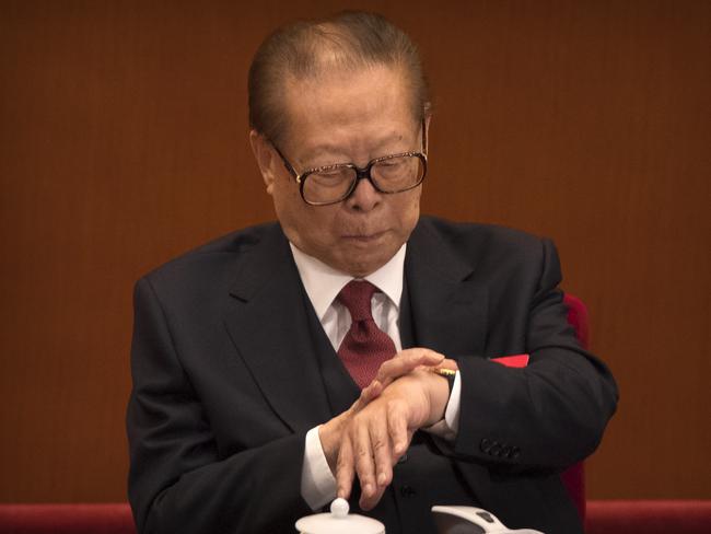 Former Chinese President Jiang Zemin checks his wristwatch during the three hour speech. Picture: AP Photo/Mark Schiefelbein