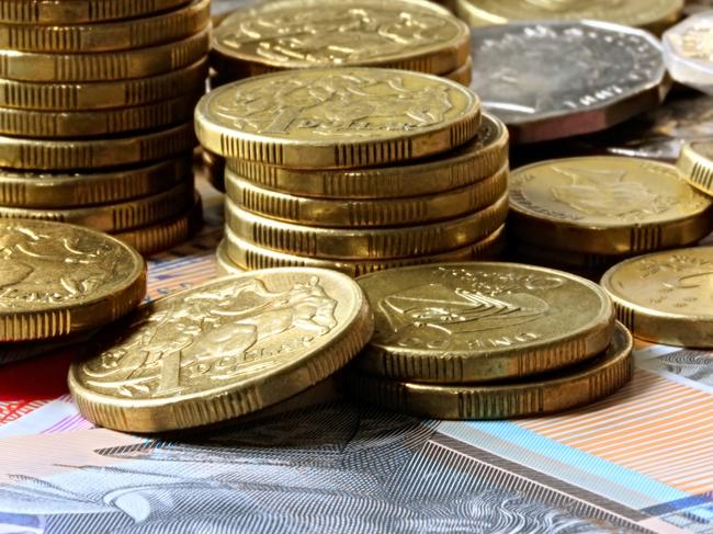 Stacks of Australian coins on Australian notes. Money generic