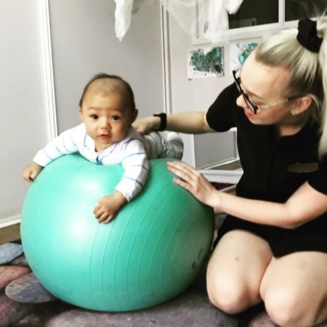 Tummy time with early learning educator Charlotte Leahy and baby Kazuri Grey. Picture: Supplied