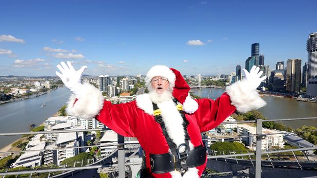 Santa scales the Story Bridge in search for new Christmas recruits. Photo Steve Pohlner