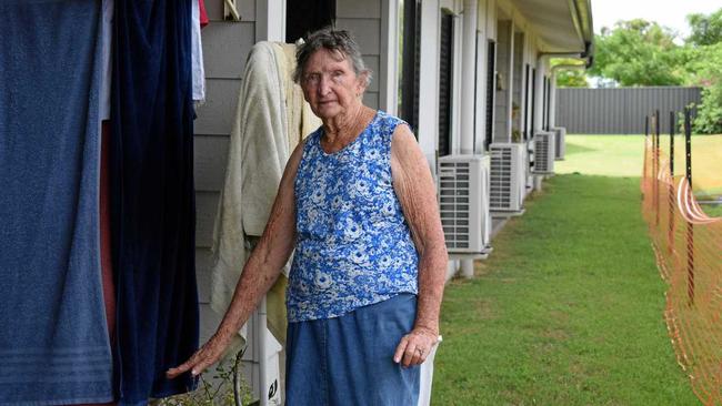 Eva Gorrie shows how high the sandbags were stacked to keep water off their doorsteps. Picture: Steph Allen