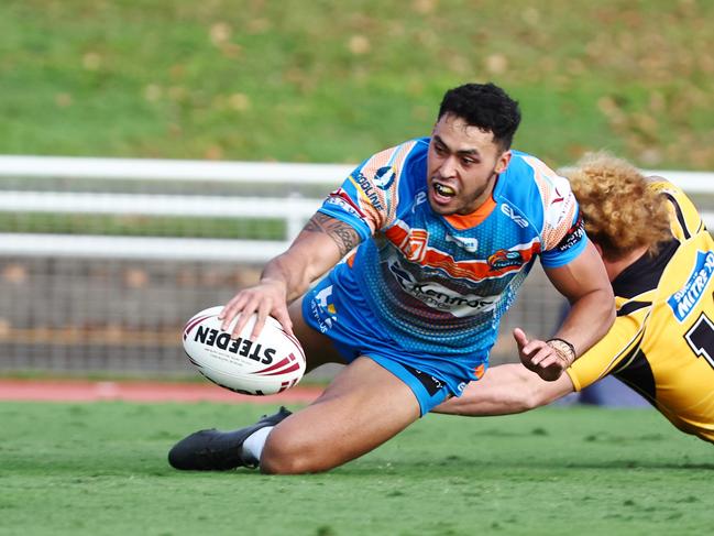 Pride's Jensen Taumoepeau gets past Caius Faatili to score a try in the Hostplus Cup Queensland Rugby League (QRL) match between the Northern Pride and the Sunshine Coast Falcons, held at Barlow Park, Cairns Picture: Brendan Radke