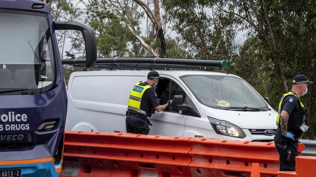 Police check for entry permits to Victoria in Mallacoota on Thursday. Picture: Getty Images