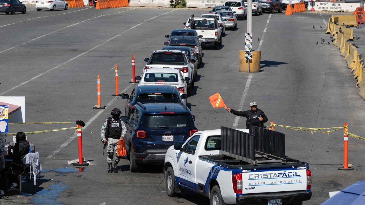 Mexico's National Guard officers check cars heading to the United States at the San Ysidro crossing port in Tijuana, Baja California State, Mexico. Picture: Guillermo Arias / AFP.