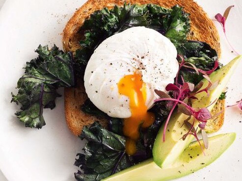 Poached egg with wilted kale and avocado.