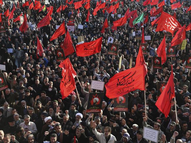 Iranian demonstrators chant slogans and hold anti-Saudi placards and flags during a rally to protest the execution by Saudi Arabia last week of Sheikh Nimr al-Nimr. Picture: AP