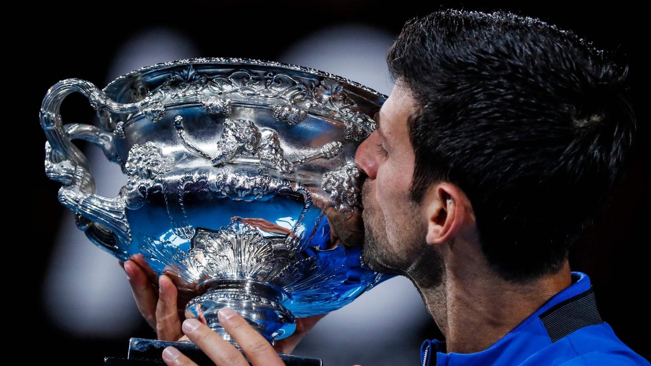 Serbia's Novak Djokovic celebrates with the championship trophy on Sunday night.