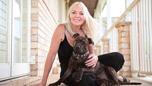 Debbie Moodie at her home with a stray she is rehousing. Picture: Adam Yip