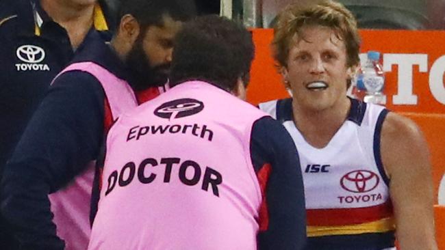 IN PLAY: Adelaide vice-captain Rory Sloane receives treatment after hurting his knee against Essendon last week but he trained strongly yesterday to put his hand up for selection against Sydney. Picture: Scott Barbour (AFL Media/Getty Images).