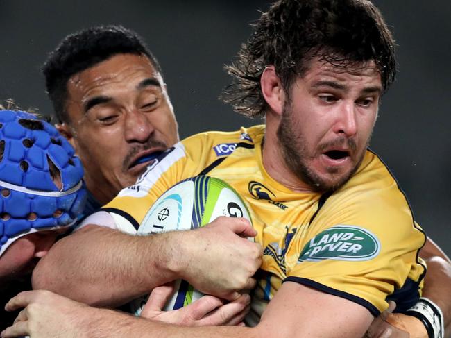 AUCKLAND, NEW ZEALAND - JULY 08: Sam Carter of the Brumbies is tackled by Jerome Kaino of the Blues during the round 16 Super Rugby match between the Blues and the Brumbies at Eden Park on July 8, 2016 in Auckland, New Zealand. (Photo by Phil Walter/Getty Images)