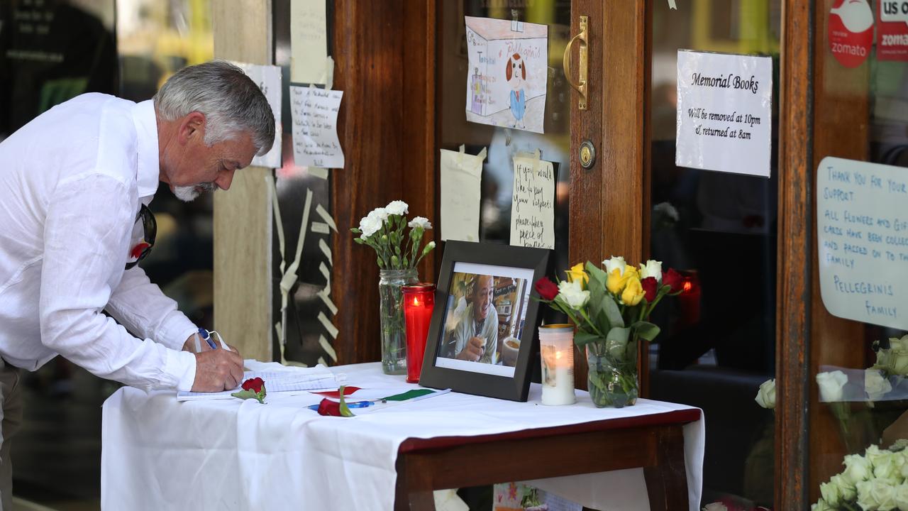 A man signs a condolence book for the Bourke Street tragedy. Picture: David Crosling
