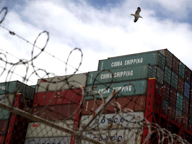 (FILES) In this file photo taken on June 20, 2018, shipping containers sit on the the Hong Kong based CSCL East China Sea container ship at the Port of Oakland on June 20, 2018 in Oakland, California.  The US is expected to see an exceptional surge in economic growth in the second quarter that US President Donald Trump can use to trumpet the success of his economic agenda. But the unusual result, which economists say could be the strongest in four years, is partly thanks to Trump's trade wars, and those same disputes threaten to drag growth lower in the coming months and years.  / AFP PHOTO / GETTY IMAGES NORTH AMERICA / JUSTIN SULLIVAN