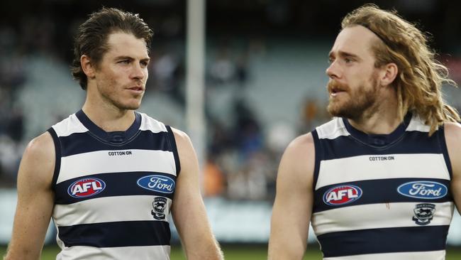 MELBOURNE, AUSTRALIA - APRIL 05: Isaac Smith and Cameron Guthrie of the Cats look on after a win during the 2021 AFL Round 03 match between the Geelong Cats and the Hawthorn Hawks at the Melbourne Cricket Ground on April 05, 2021 in Melbourne, Australia. (Photo by Dylan Burns/AFL Photos via Getty Images)