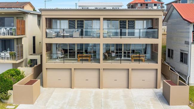 The front row oceanfront-reserve triplex fetched $5.8m in Yamba sold to a couple who only registered in the final minutes of the onsite auction.