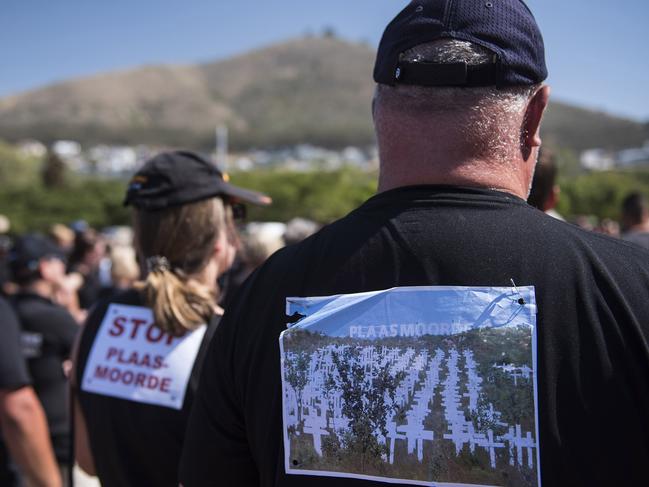 South African farmers & farm workers attend a demonstration at the Green Point stadium to protest against farmer murders in the country, on October 30, 2017, in Cape Town. Thousands of white farmers blocked roads in South Africa on October 30 to protest against what they say is an explosion of violence against their communities in rural areas. Large demonstrations under the "Black Monday" banner were held in Cape Town, Johannesburg and the capital Pretoria. Marchers dressed in black to commemorate the victims of hundreds of deadly "farm attacks" in recent years. / AFP PHOTO / DAVID HARRISON