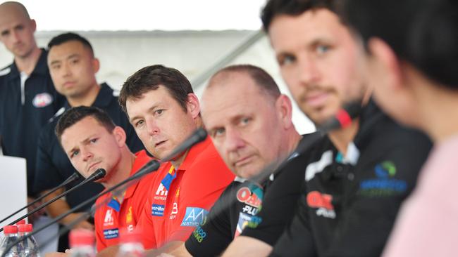 Gold Coast skipper Steven May, coach Stuart Dew and Port coach Ken Hinkley and captain Travis Boak at Thursday’s press conference. Pic: AAP