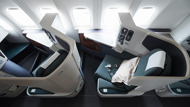 Cathay Pacific business class seats extent to full lie-flat beds for restful sleep and relaxtion