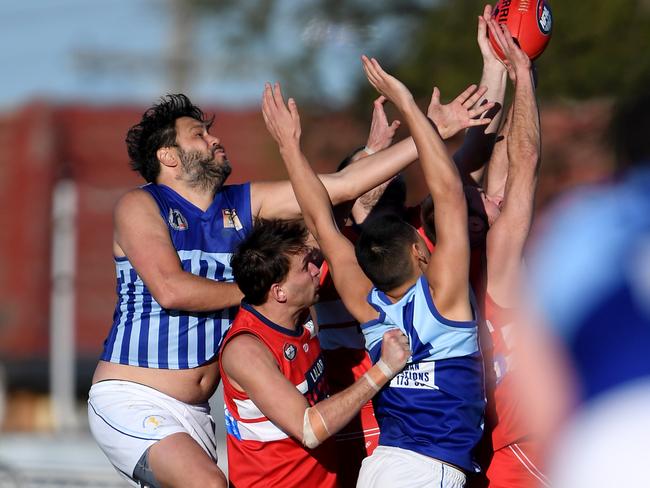 Lalor and Reservoir players fly for the ball. Picture: Andy Brownbill