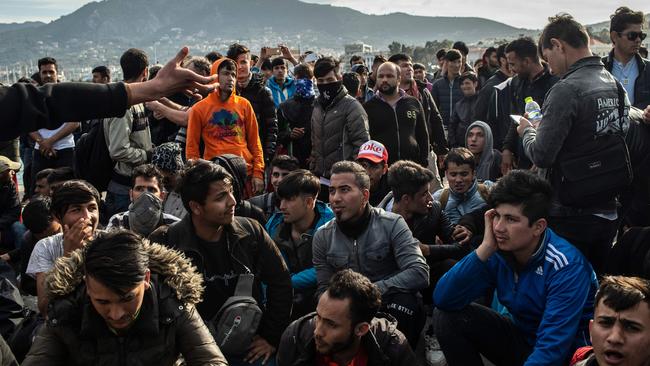 Asylum-seekers block a road outside port of Lesbos amid a migration surge from neighbouring Turkey. Picture: AFP