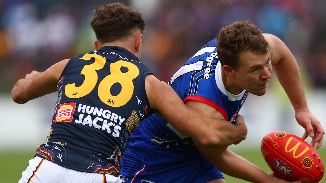 Jack Macrae of the Bulldogs (R) is tackled by Lachlan Sholl of the Crows during the round 10 AFL match between Western Bulldogs and Adelaide Crows at Mars Stadium on May 20, 2023 in Ballarat, Australia. (Photo by Graham Denholm/AFL Photos via Getty Images )