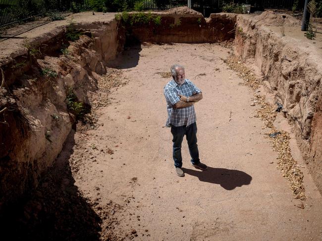 Councillor Glenn Milne inspects one of the pools allegedly at the centre of the case. Picture: Jake Nowakowski