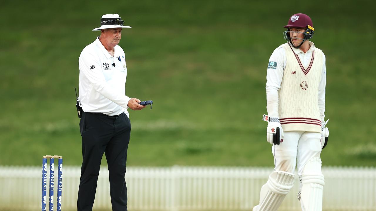 Umpire Greg Davidson takes a light reading as Matt Renshaw shows his frustration. Picture; Mark Kolbe/Getty Images