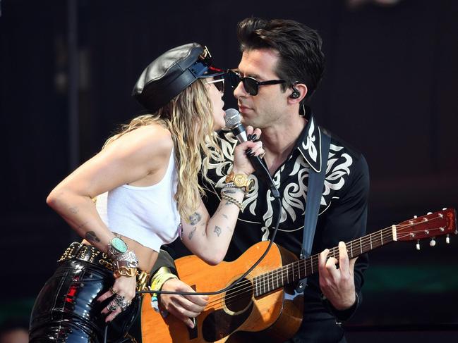 Miley Cyrus lights up the stage with Mark Ronson at Glastonbury last month. Picture: AFP