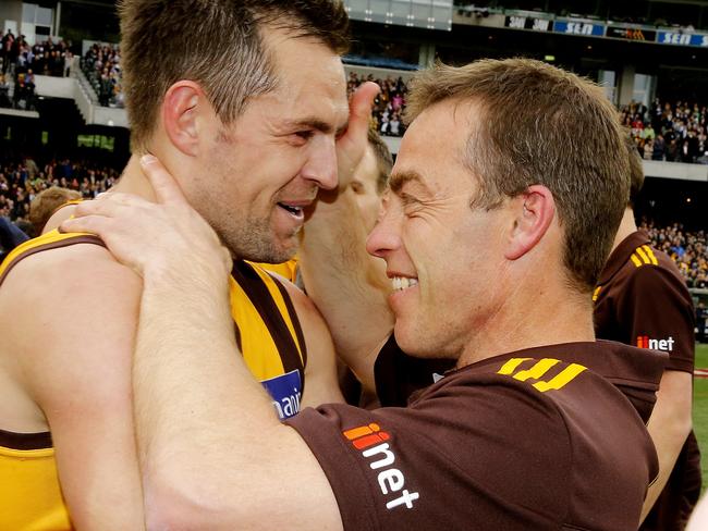 Luke Hodge and Alastair Clarkson share a special premiership moment. Picture: Wayne Ludbey