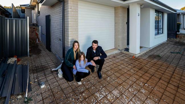 Kellie and Daniel Barratt, and Kellie's 8yo daughter Amelia Frawley. For two years the family has not had a driveway. Image/Russell Millard Photography